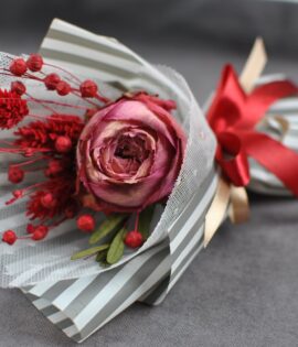 red rose on white and red gift box